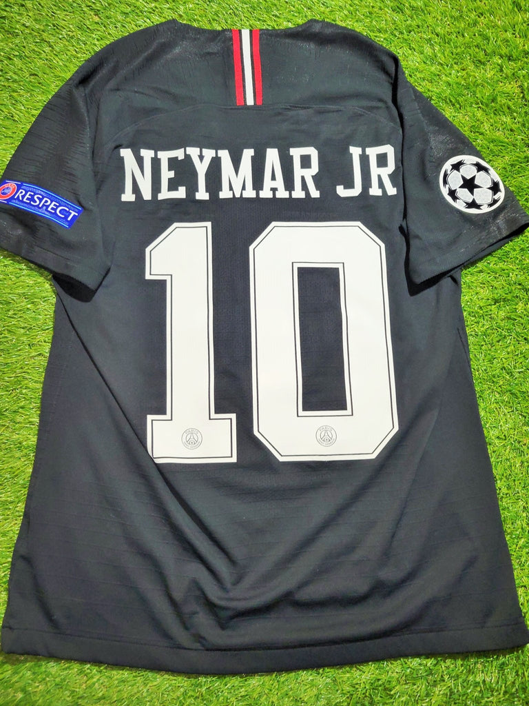 Neymar Jr. posing in PSG's black CL kit with the Air Jordan logo